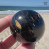 Flashy Nuummite Premium Sphere - Genuine Greenland Crystal Ball - Empath Protection 1.6" Palm Stone Orb - Blue Gold Flashes
