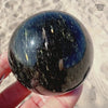 2.2" Fireball Nuummite Sphere - Genuine Greenland Stone Crystal Ball - Empath Protection Palm Stone Orb - Shooting Stars Blue Gold Flash