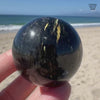 Genuine Nuummite Sphere - Blue Gold Flash Greenland Crystal Ball - Empath Protection 1.6" Palm Stone - Past Life Regression Meditation Gift